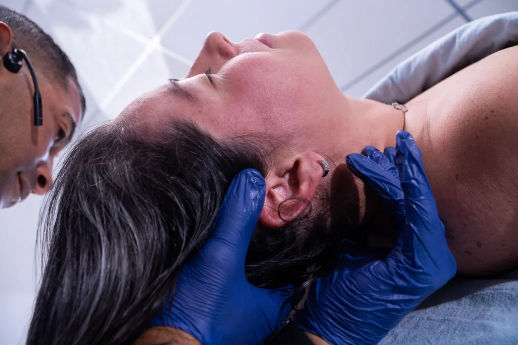 Chiropractor performing manual cervical spine therapy on a patient for chronic neck pain relief